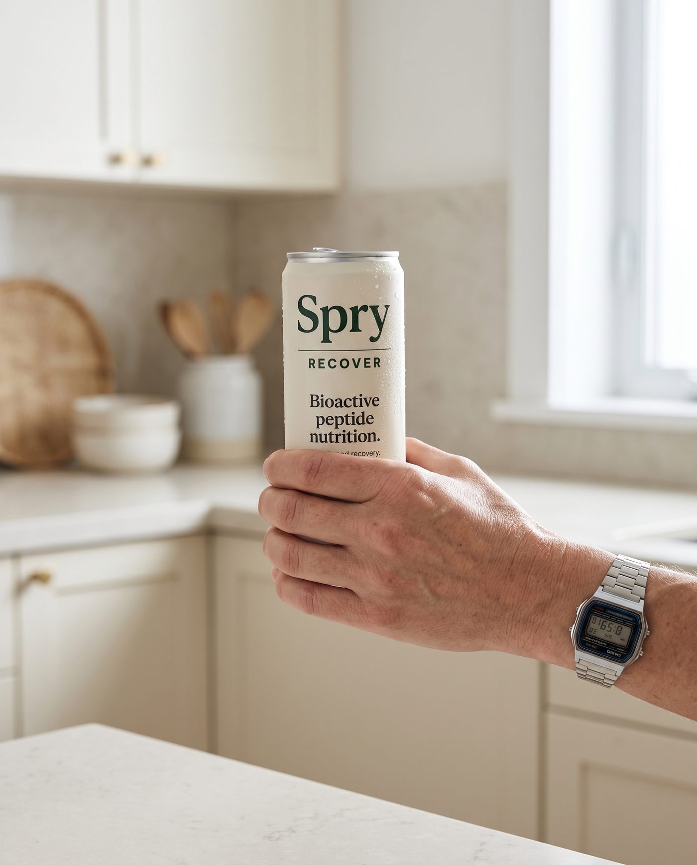 Holding a Spry RECOVER can in a kitchen